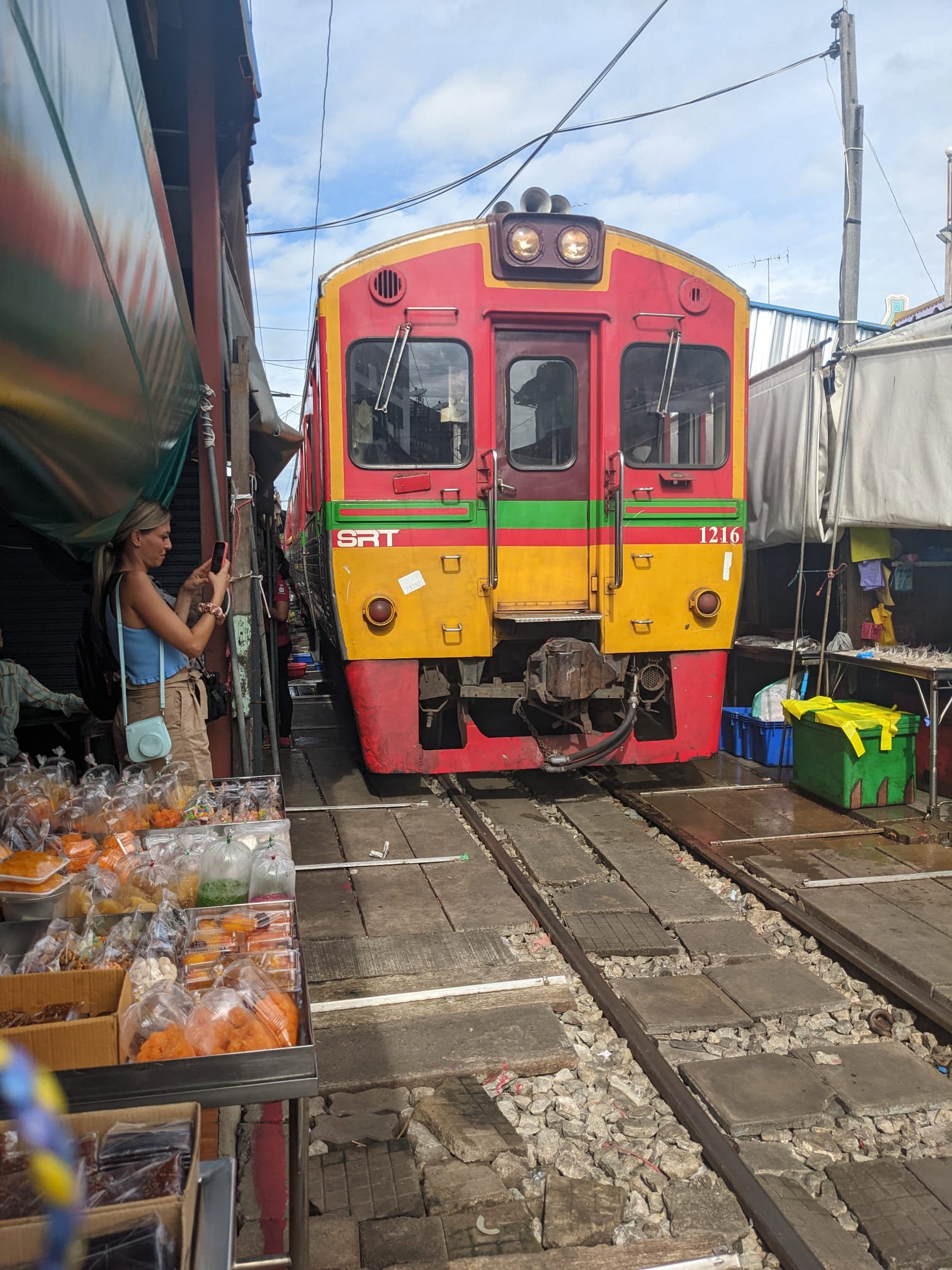 The train coming through the railway market. cost of 5 nights in Bangkok