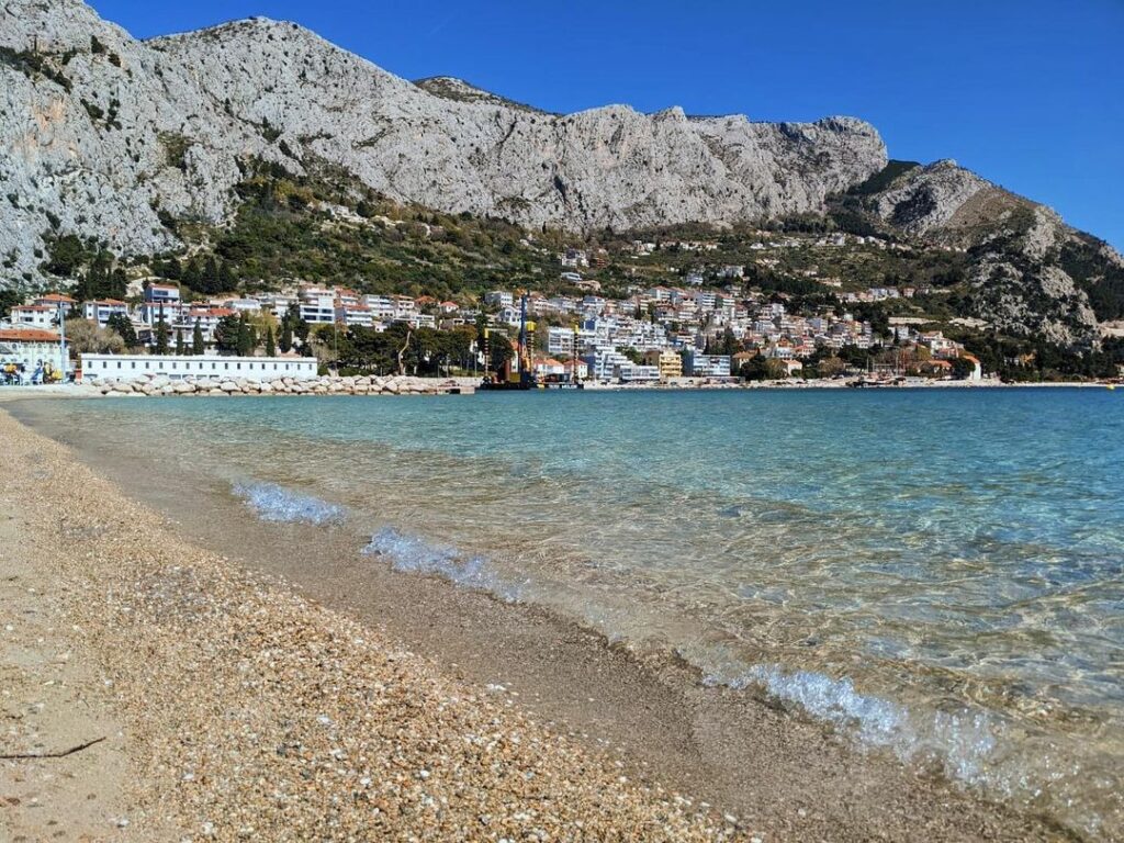 Omiš beach with turquoise waters and mountains in the background