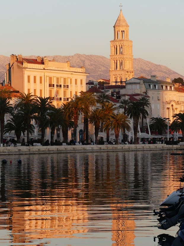 Split Old Town at sunset with the sea in the foreground and the famous bell tower in Split