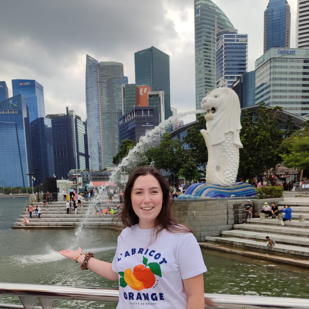 Tiani pretending to catch the water coming out of the Merlion's mouth